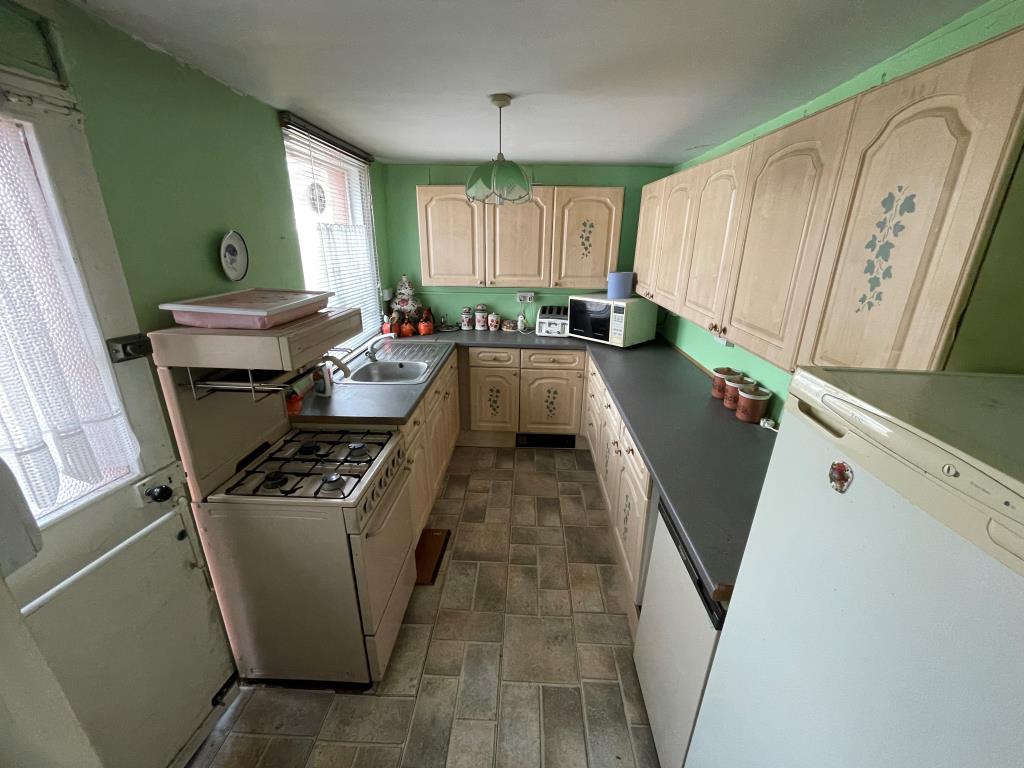 Lot: 111 - END-TERRACE HOUSE FOR IMPROVEMENT - Kitchen leading through to garden